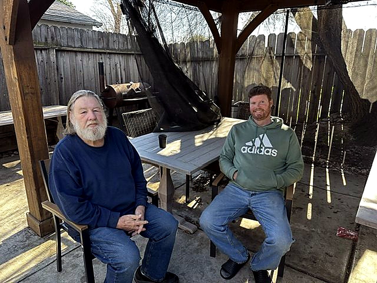 Two men relaxing together in the backyard