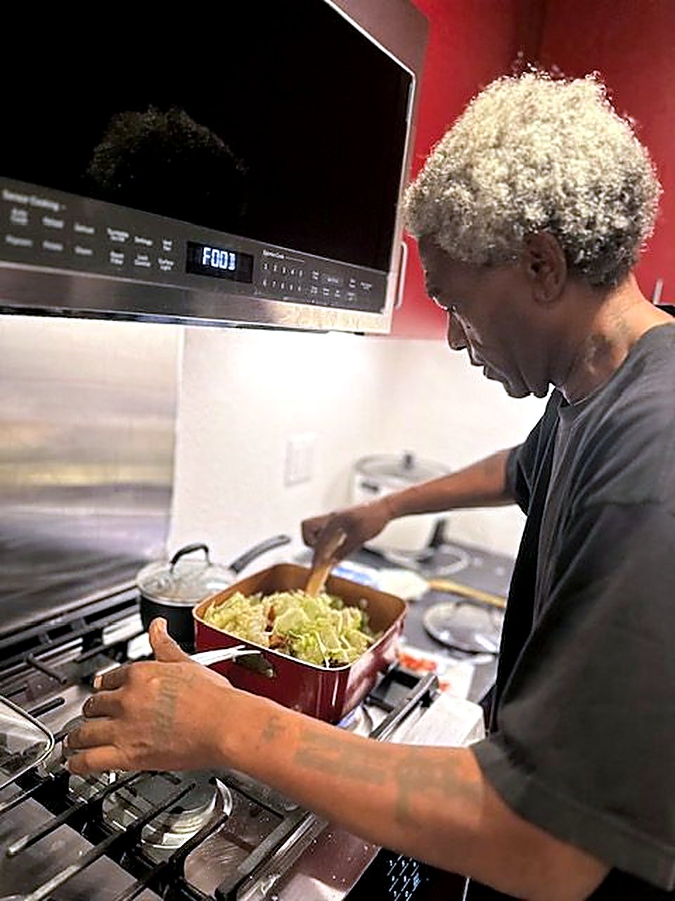 A resident cooking a meal on the stove