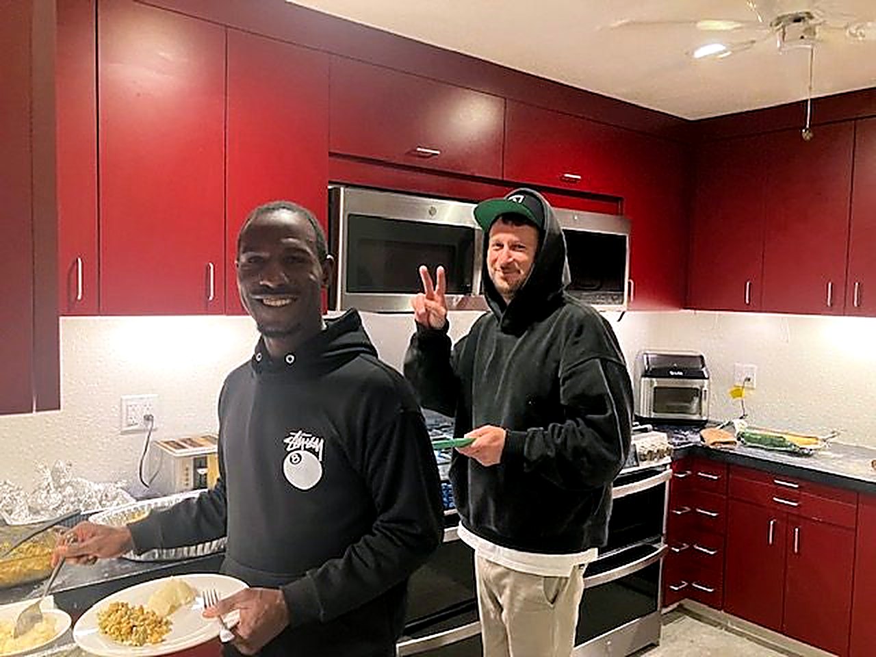 Two residents sharing a laugh in the kitchen